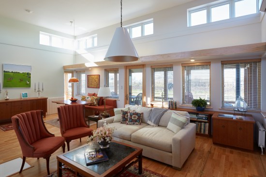 Mid-Century Mod on the Prairie - Living Room

This open-space living and dining room illustrate the ideal of Vastu living, where natural light and fresh air come into the house from many directions. 
