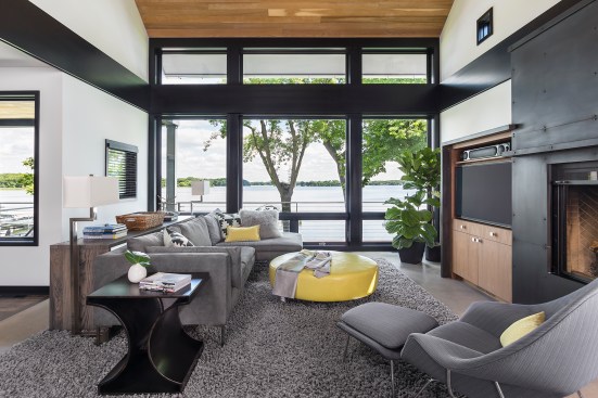 Modern living room looking out onto lake through large windows