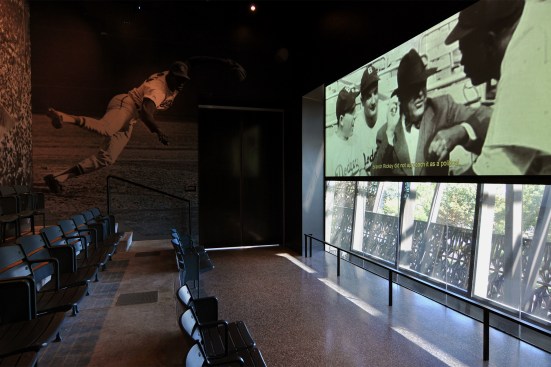 A screening room dedicated to Negro League Baseball features stadium seating and eastward views toward the Capitol. 