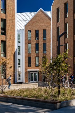 The wings of Olympia Place inflect in to shelter the main entrance  to the west and a courtyard to the  east. 