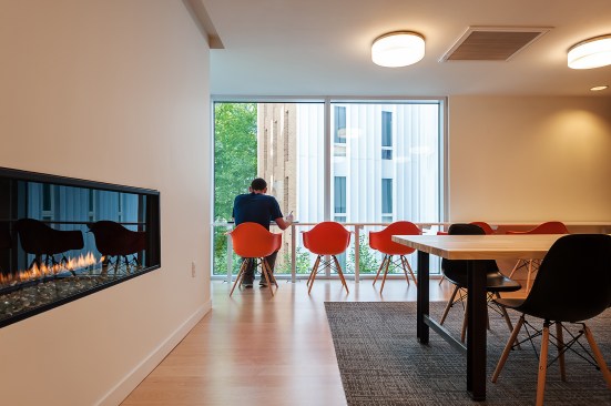 Shaw carpet and fireplaces that punch through from one room to the next unite the common spaces.