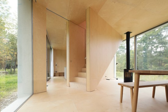 The architects designed much of the furniture in the minimalist house, including the dining table in the center of the ground floor.