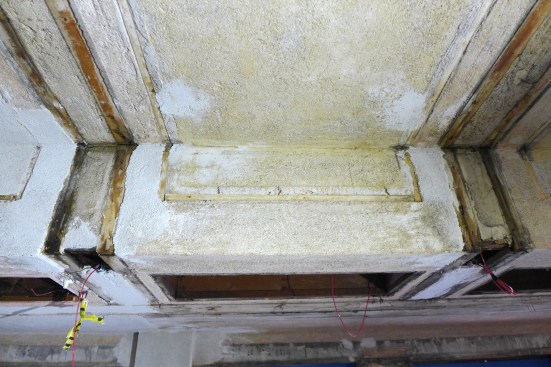 During the restoration, the wood trim was removed from the living room and cataloged before several layers of paint were stripped, exposing the original plaster surface. 