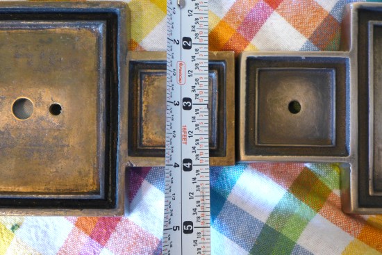 Where original globe light fixtures could not be restored, faithful replicas (at right) were crafted to match the originals (at left) and compared for accuracy.