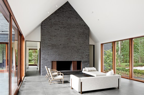 The combined living and dining area is bookended by fireplaces built from locally sourced Endicott brick.