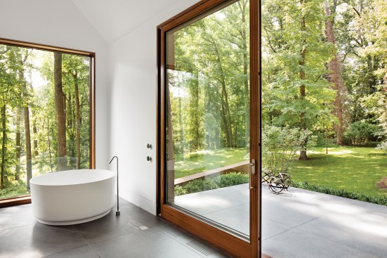 Solarban 60 glazing throughout the house, seen here in the main-floor master bath, invites the protected landscape in while promoting energy efficiency.