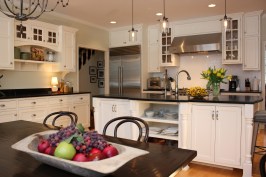 This farmhouse had received several updates and renova-
tions over the years. However, the floor plan was conflict-
ing amongst the kitchen, laundry, mudroom, and powder 
room. A complete reorganization of the first floor was 
achieved through multiple structural changes that al-
lowed for a larger kitchen and created better flow be-
tween adjacent rooms. The kitchen includes custom 
painted cabinetry, a farmhouse style sink, and soapstone 
countertops. A commercial size Viking range, hood, and 
Sub Zero refrigerator bring a theme of stainless steel to 
the kitchen which is accentuated by brushed nickel hard-
ware and island faucet. Specialty lighting, glass door 
cabinets, and a grand, eight foot island are just a few of 
the features that make this kitchen stunning.