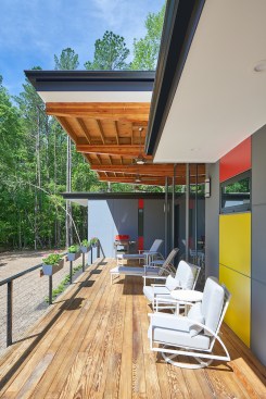 An 11-foot cantilevered roof shields the glass and provides the sheltered place for watching the rain.