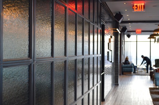 The+feature+wall+by+the+bar+showcases+Bendheim%e2%80%99s+textured%2c+opaque+VintageWire+glass+framed+in+dark+wood.+