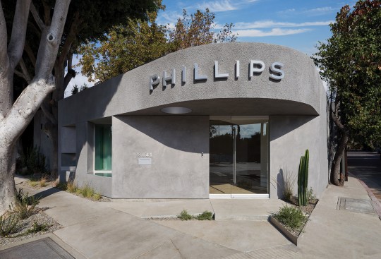 This LA renovation for the auction house Phillips transformed existing buildings into bright, pared-back galleries. Fenestrations are “cut obliquely into a thickened perimeter wall, simulat[ing] a medieval hagioscope,” explains the firm in a project description.