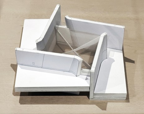 Model of a space between galleries, showing folded walls pulled apart from the corners.