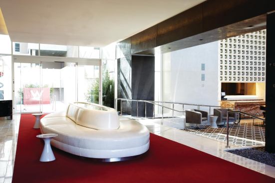 At the main guest entrance, the red terrazzo carpet that signifies the approach to the hotel continues inside in the form of a plush red carpet.