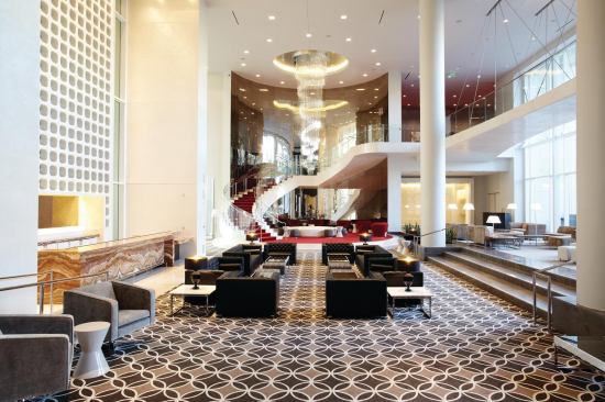The double-height lobby of the W Hollywood has touches of silver-screen glamour. A chandelier of dangling Swarovski crystals dominates the red runner-clad circular staircase that leads to the second floor, which houses meeting rooms and spaces for celebrity press junkets.