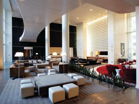 Several discrete seating areas allow for people watching and for wheeling and dealing. The second floor catwalk becomes a sculptural element in the space, and a double-height curtain wall overlooks Hollywood Boulevard.