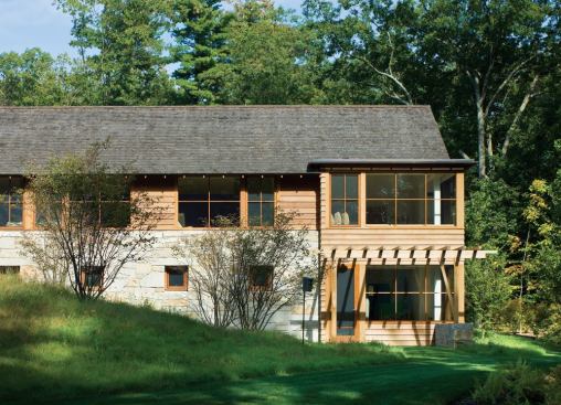 Located at the east end of the house, where the grade falls away, the master bedroom gains privacy by being one story off the ground.