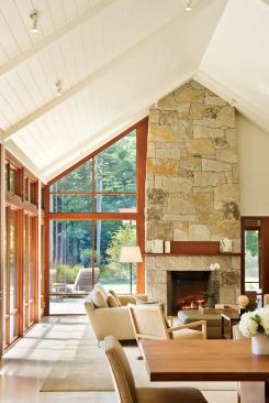 A granite fireplace and chimney anchors the west wall of the kitchen great room.