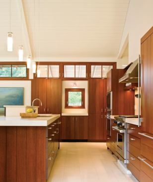 The kitchen cabinets, like all the millwork in the house, are mahogany. The floor and counters are limestone.