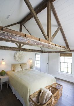 Raising the ceiling to the newly insulated roof opens up the master bedroom and exposes the timber-framed roof truss accenting the nature of the renovations.