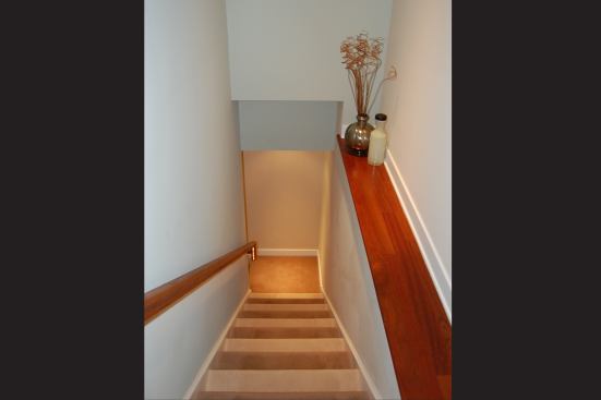 When the Taukes decided to use alternating carpet colors on stair treads, “we both knew it was something that, aesthetically, could go bad very quickly,” says Beth Tauke. To keep up appearances, the sisters opted for a light- and dark-beige combination that stays subtle while still offering visual assistance.