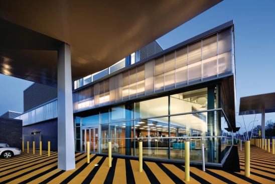 The designers came up with an unexpected solution: polycarbonate panels, which cost less than ballistic-rated insulating glass units, have a high insulating value, and harvest daylight for the federal facility.