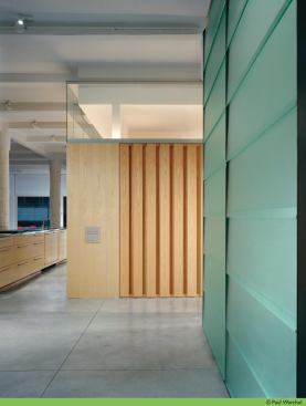 The slats on the media wall in the Madison Square loft can be tilted manually to brighten the living area.