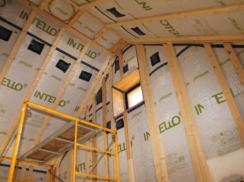 Figure 19. On the interior, Intello Plus was installed over the wood I-joists, and then the walls were furred out with 2-by strapping. Dense-pack cellulose was blown in from the inside. The electrical was run in the 1 1/2-inch furred-out space, and shallow electrical boxes were used to house the switches and receptacles.