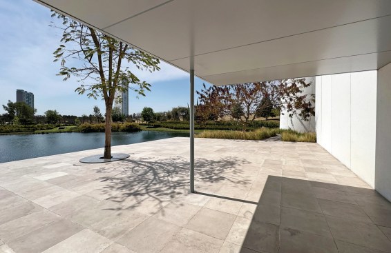 View of a small lake and undulating landscape beyond the museum.