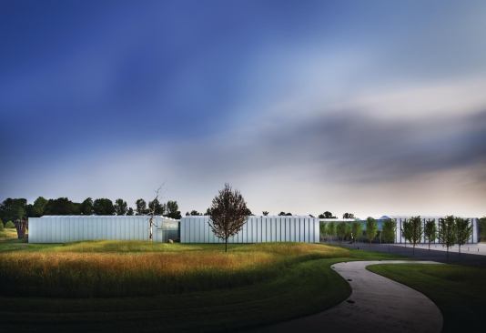 The new building at the North Carolina Museum of Art provides more than 65,000 square feet of exhibition space, in addition to public areas such as a store and a café. The entry plaza is delineated by a tree-lined path that leads to a 2-1/2-acre environmental art installation (completed in 1997), which includes an amphitheater by New York architects Smith-Miller + Hawkinson, a sprawling environmental work by conceptual artist Barbara Kruger, and landscaping by Nicholas Quennell.
