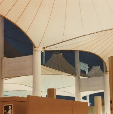 Teflon-coated fiberglass fabric canopies attach to the 147-foot-tall masts.