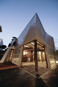 Corner sliding doors open onto a private terrace.