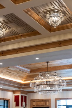 The Main Lobby ceiling uses Ceilume thermoformed coffers, set within millwork beam coffers, to present an array of crystal chandeliers, a show of traditional opulence that gives a formal context to the rustic cowboy-inspired elements.