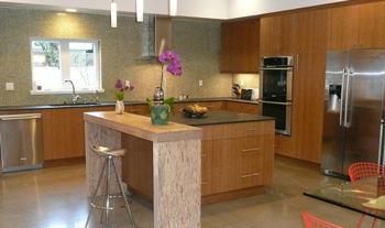 The home's Energy Star-rated refrigerator and dishwasher were provided by Electrolux. Other features in the kitchen include KlipBio Technologies' biocomposite countertop, an in-cabinet composter from NatureMill, Chianti LED pendant lights from Bruck Lighting, and Hakatai Ashland-e tiles made with 70% post-consumer recycled glass.