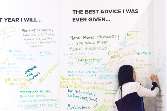 A WLS 2019 attendee contributes to a crowdsourced motivational board.
