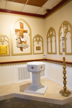 Above the new baptismal font, a border of the original, water-damaged mineral fiber ceiling had not yet been replaced when this photo of the new baptismal font was taken.