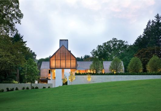 The street-facing, wood-detailed gable acts as a beacon in the evening.