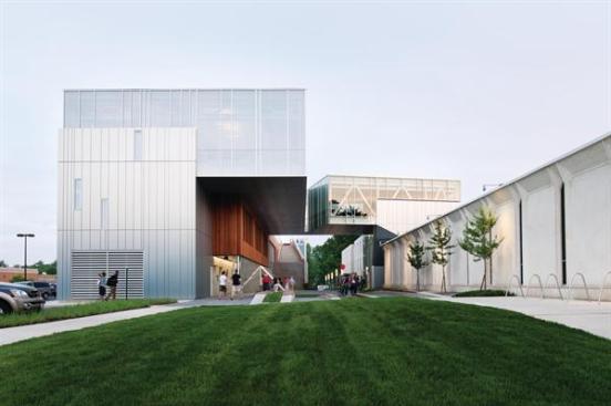 The buildings exterior wall system is a Reynobond composite metal panel of which the provenance has a local connection: Bauxite was first processed into aluminum in Oberlin by scientist Charles Martin Hall. The milled brush finish plays with the light in a way that evokes the adjacent Yamasaki buildings; their white concrete has an opalescent aggregate that gives the white a great deal of depth.