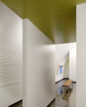 Careful fixture placement allows the lighting to highlight the compositional relationship of the architecture's surfaces, color, and texture.