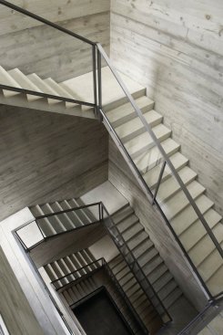 A skylit stairwell rises all five levels of the building.