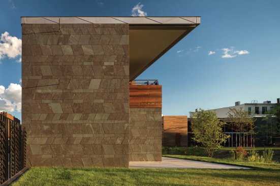 Slate tiles are laid in a pattern inspired by traditional African motifs.