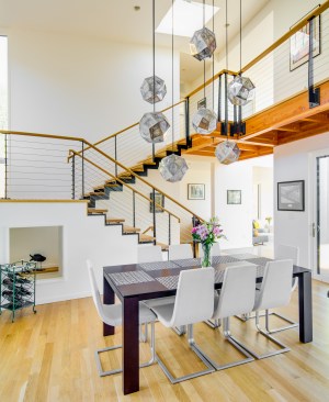 The extraordinary staircase crafted by Rutledge Staircase and Handrail connects to the upstairs rooms