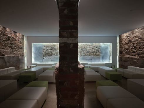 Salon A and B-the two remaining salons-are mirror images of each other. Along each side, concealed track fixtures with infrared-coated PAR lamps, heighten the texture of the stonewalls.
