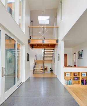 The staircase and bridge on the second level function as more than just pathways. In combination with the array of strategically placed glass, the architects intention is to "make you have the sense of moving from room to room, not room to hallway to room."