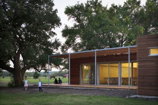 The new sanctuary addition nestled between the hedge trees and the historic schoolhouse structure offers a site sensitive response to scale, materiality, shelter, and expanse.