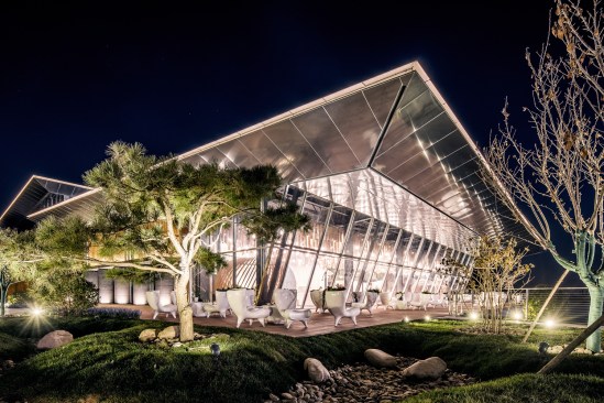The community center's new facade and entrance work in harmony with the natural surroundings.