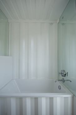 The home is equipped with water-conserving faucets, integrated greywater, and water harvesting and storage systems.