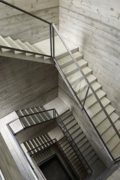 A skylit stairwell rises all five levels of the building.