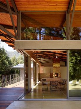 The dining area’s concrete floor flows outdoors to become a patio surface.