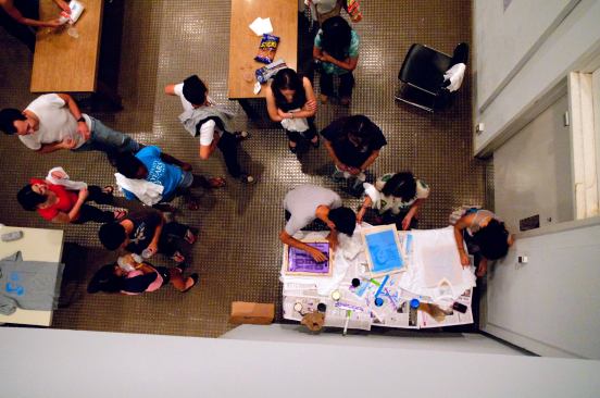 Students silk-screening a t-shirt inspired by a quote from Adriaan Geuze's lecture: “I will design you a park. I will design your shoe. I am designing even this brownie.”