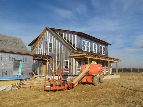 Vertical wooden slats attached to the exterior of the house will create an air space between the side wall and fiber cement siding.