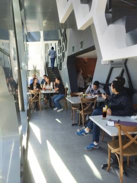 The restaurant also has tables within the façade expansion. The staircase leads to another pod.